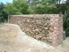 Basalt stone wall with brick coins