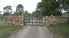 Drystone sandstone entrance wall with electric gates