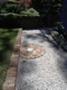 Sandstock brick retaining wall and gravel path with feature
